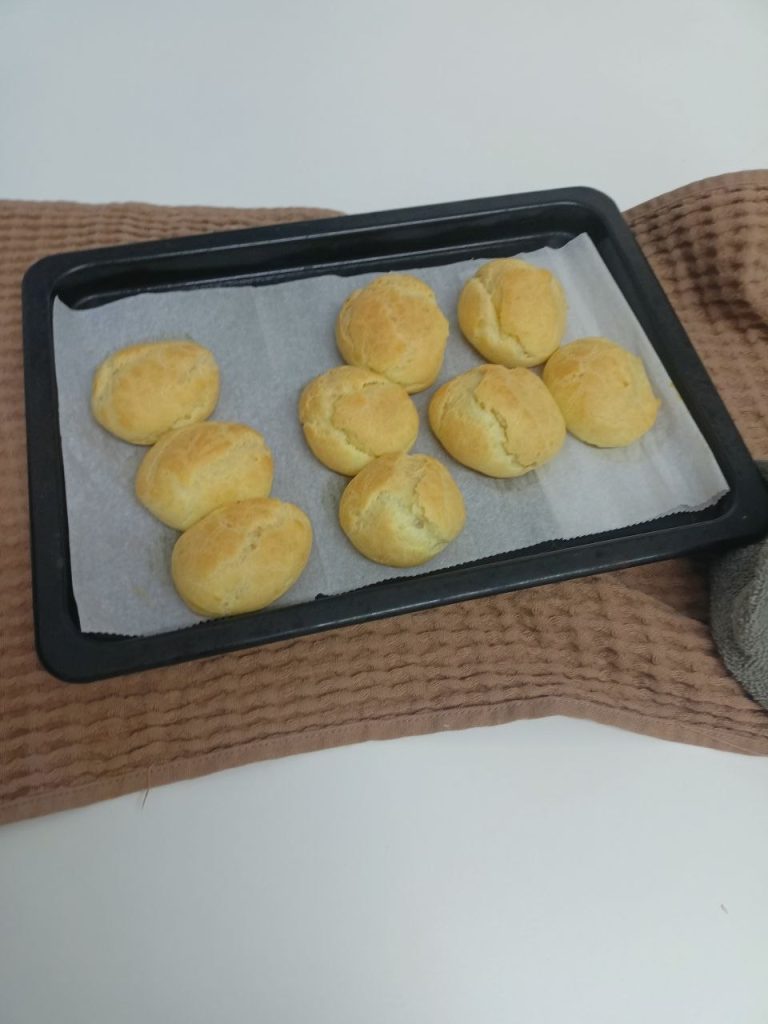 homemade cream puffs baked on parchment paper